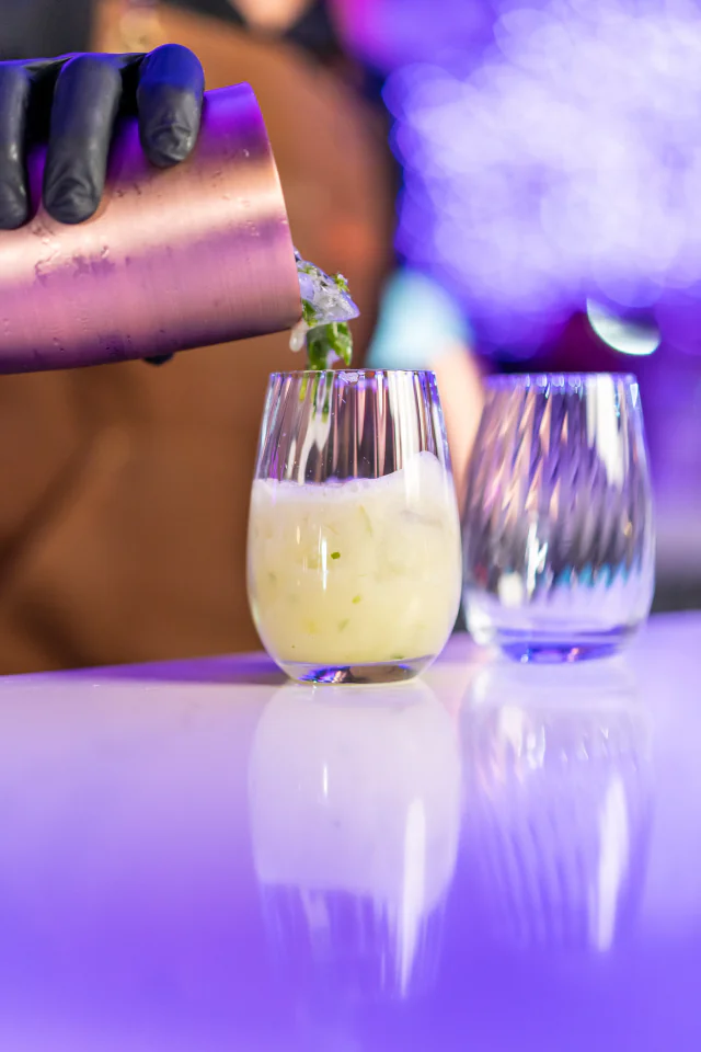 Bartender pouring a cocktail at the bar
