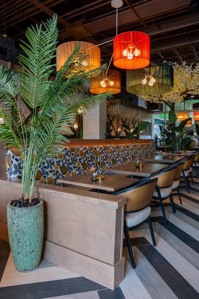 Banquette seating under pendant lamps in the dining room