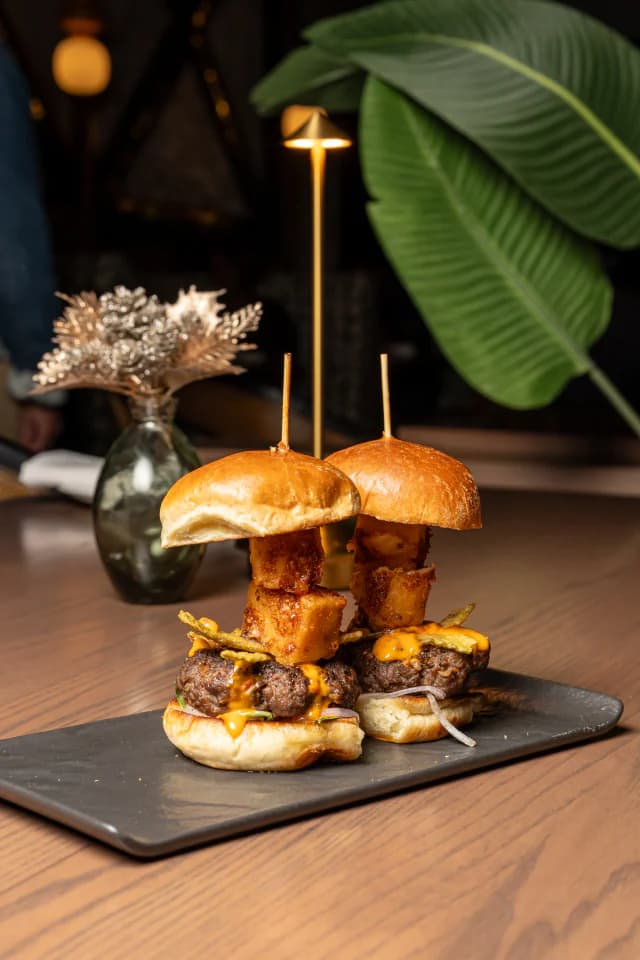 Skewered sliders served on a slate board