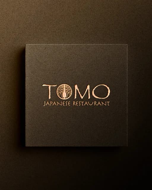 A Tomo presentation box with the logotype in gold