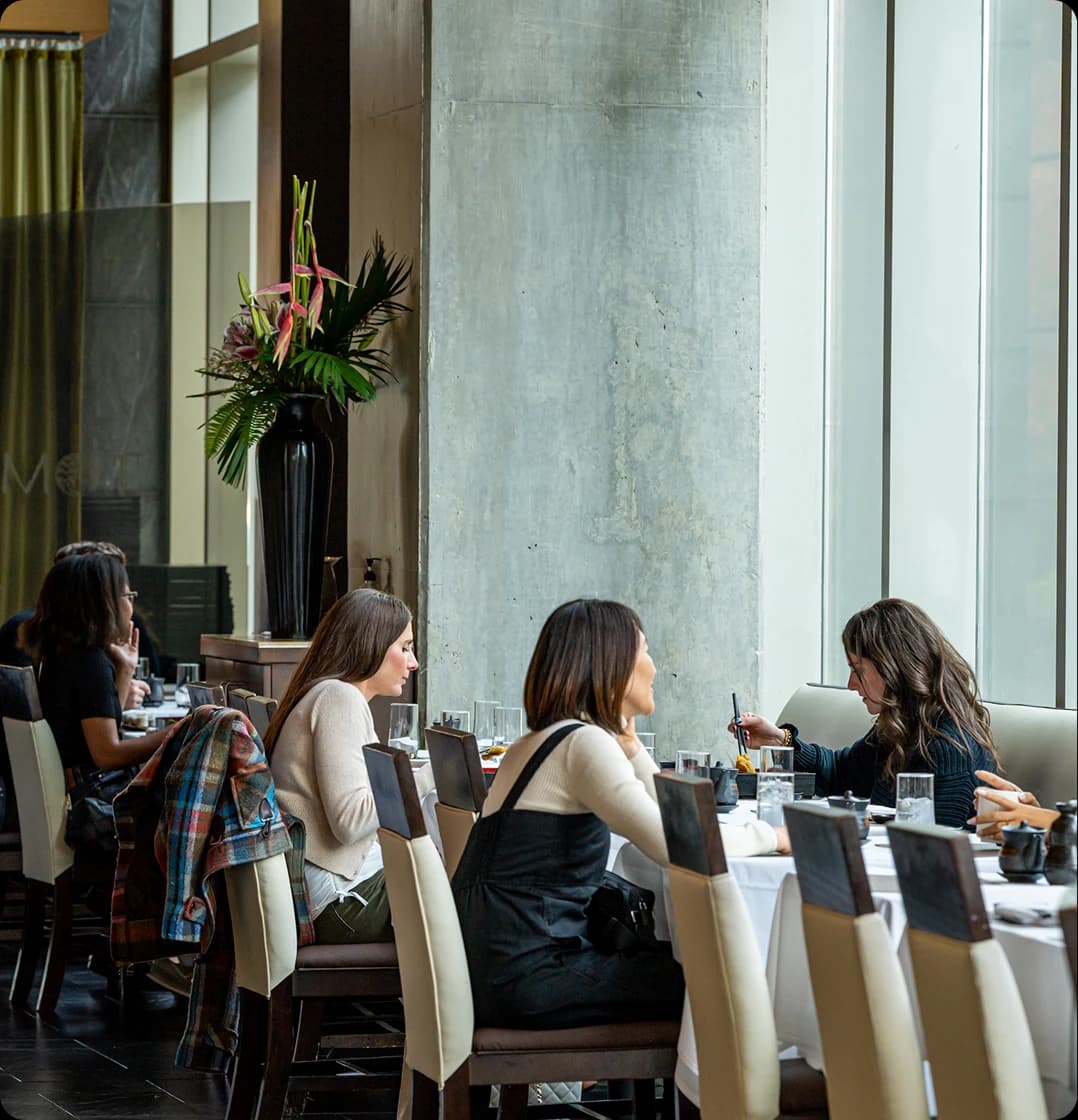 Guests dining by the windows at Tomo Japanese