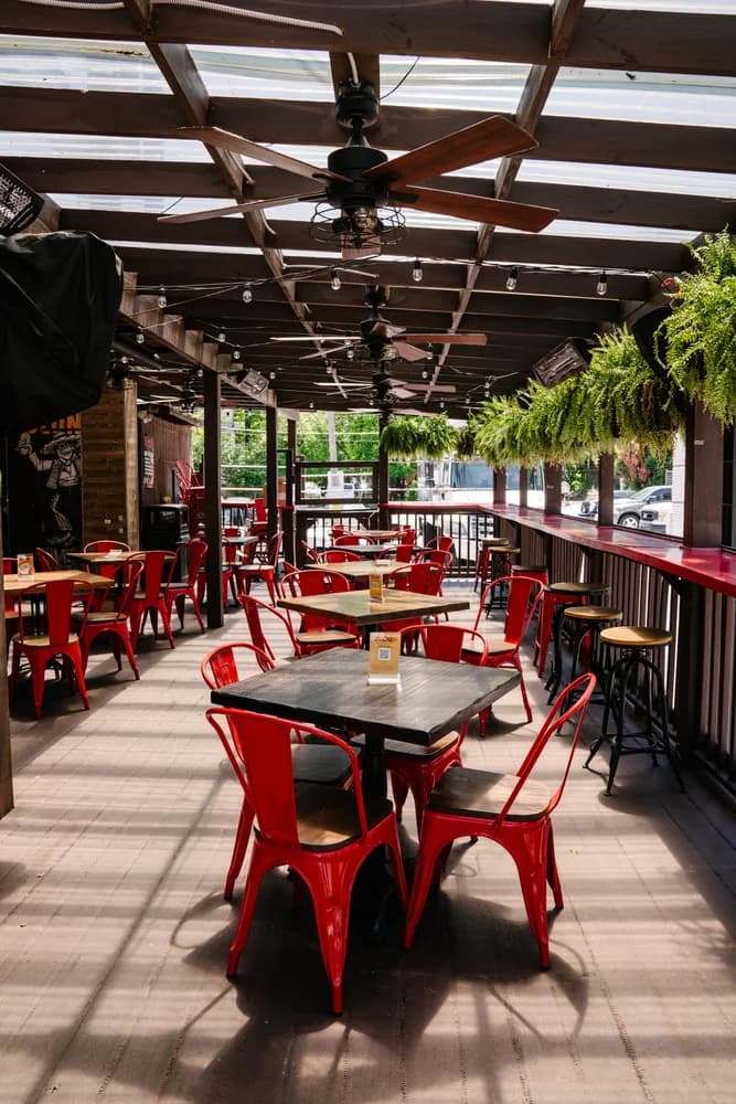 Red chairs on the covered patio at Zócalo