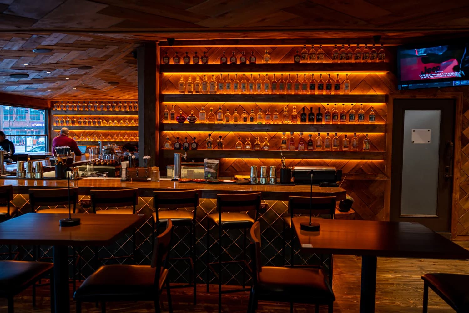 Backlit tequila shelves behind the bar at Zócalo